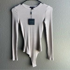 Very flattering bodysuit in Tan. Size medium.